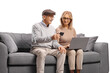 © Ljupco Smokovski - Mature couple sitting on a sofa and making an online payment
