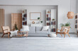 © Pixel-Shot - Bookcases, cozy sofa, wicker armchairs and coffee table in interior of stylish living room