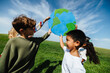 © (JLco) Julia Amaral - Children lifting globe to promote caring for the planet