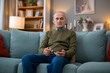 © Dexon Dee - Senior man testing blood sugar with glucometer