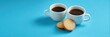 © Iryna - Two cups of coffee with biscuits on bright blue background