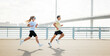 © muse studio - Runners enjoy a morning jog along the waterfront near a bridge in a city