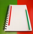 © Юлія Кокоріна - Open notebook with blank page and red and green penscils on red and green background, bisiness and financial planning concept