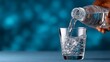 © Nataliia_Trushchenko - A person is pouring water into a glass. The water is clear and the glass is half full