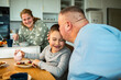 © Geber86 - Father kissing son at breakfast in home kitchen