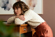 © Anna - A thoughtful pensive woman in a cozy sweater leaning on a wooden desk at home. Portrait of a sad person in quiet contemplation. Mental health and introspection concept