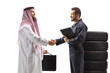 © Ljupco Smokovski - Auto mechanic shaking hands with an arab man in a thobe