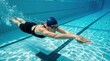 © Philipp - Female swimmer underwater freestyle training in blue swimming pool