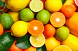 © New Africa - Different ripe citrus fruits and leaves with water drops as background, top view