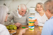 © JackF - Elderly man and woman friends playing board game bricks at table