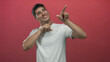 © Krakenimages.com - Young hispanic man wearing a casual white tshirt smiling and pointing finger in red studio setting; curiosity.