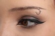 © New Africa - Woman with eyebrow piercing and perfect makeup, closeup