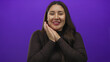 © Krakenimages.com - Young hispanic woman with closed eyes smiling and hands clasped under chin gesture in studio setting; serenity.