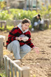 © JackF - Female gardener planting seeds garlic on beds at farm