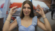 © Krakenimages.com - Teen girl gesturing with hands on cruise ship deck building, wearing blue top and bracelets; playful curiosity.