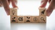 © Santri - Wooden cubes featuring innovation concepts arranged by fingers using macro clarity and bright subtly blurred white environment.