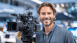 © Gusion - A smiling man operating a professional video camera in a studio.