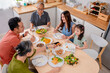 © Kawee - Asian loving family spending quality time, having dinner in cozy house.