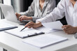 © Charlie's - Auditor or internal revenue service staff, Business women checking annual financial statements of company. Audit Concept.
