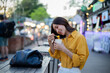 © Laingzaifa - Asian women enjoy delicious street food at night markets, smiling throughout their vacation, exploring the city's culture, vibrant lights, and fun-filled adventures.