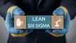 © Onetrick  - Business process improvement concept: Professional wearing industrial gloves holding a Lean Six Sigma block with automation and manual control icons