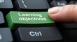 © SL Creations - Finger Pressing Green Learning Objectives Button on Computer Keyboard