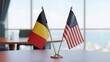 © AR Creations - Belgian and American flags on a table in a modern office setting