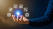 © Rahman - Businessman holding hand with glowing icons floating above palm in air