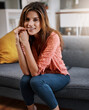 © peopleimages.com - Portrait, smile and woman relax in living room with peace, calm and comfort on weekend break. Chill, home and happy person on sofa in apartment for wellness, me time or staycation in Switzerland