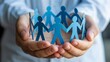 © Chetanraj - Unity and Teamwork Support Concept, Paper People in Protective Hands, Community Care and Collaboration