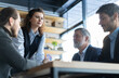 © opolja - Happy middle aged business woman discussing project management working with colleagues company team at office