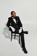 © LIGHTFIELD STUDIOS - Elegant young man in stylish tuxedo showcasing fashion and charm in a modern setting
