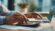 © Lumi Stock Studio - close up of hands using calculator and laptop for financial planning, person calculating mortgage payments and taxes, financial advisor or homeowner managing budget and home loan accounting