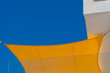 © yaqui_villegas - Abstract modern canopy membrane in yellow and blue creating shade and geometry against open sky with space for branding and summer events