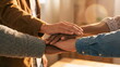 © CK Studio - Diverse group of hands stacked, symbolizing unity, teamwork, and collaboration. Warm light emphasizes connection and support in a corporate or community setting.