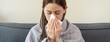 © Pormezz - Flu and common cold in winter season concept, Woman sneezing on the bad and have fever resting at home.