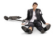 © Ljupco Smokovski - Injured businessman sitting on the floor after an e-scooter accident