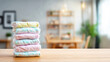 © Bonsales - Stack of colorful baby diapers on light wooden table, preparing for newborn care and family comfort concept