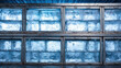 © Syphachan - Frozen Display: A series of square windows reveals a mesmerizing display of ice blocks, their translucent forms creating an abstract texture of cool tones and icy formations.