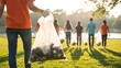© sajibul35 - Family and friends volunteering together collecting trash outdoors in nature at sunset with protective gloves and bags
