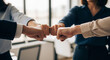 © KAMRAN - Row of business professionals fist bumping together perfect for partnership and motivation concepts
