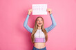 © deagreez - Happy young woman holding a calendar with marked dates on pink background showcasing cheerful and lively energy