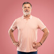 © opolja - Portrait of smiling happy mature grey-haired man standing on pink background