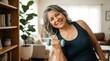 © Running opossum - joyful middle-aged woman exercising with dumbbell in cozy living room, healthy lifestyle focus