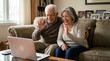 © Running opossum - senior couple video calling family on laptop from cozy living room