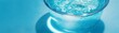 © Ytnart - A refreshing glass of clear water splashes against the sides, surrounded by an invigorating blue background. Perfect for promoting hydration and wellness in lifestyle visuals.