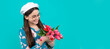 © Olena - cheerful child in beret with tulips. mothers or womens day. kid in glasses. Banner of spring child girl with tulips flowers bouquet, studio portrait with copy space.