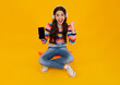 © Olena - Amazed teenager use smart phone, share social media, chatting by mobile phone wear stylish casual trendy clothes isolated over yellow background. Kid showing blank screen mobile phone.