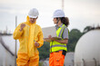 © JU.STOCKER - Specialized technical team performing chemical analysis and ecological monitoring near a petrochemical plant to ensure environmental compliance, Environmental scientist inspecting a water sample