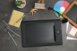 © Pixel-Shot - Graphic tablet with stationery on dark background